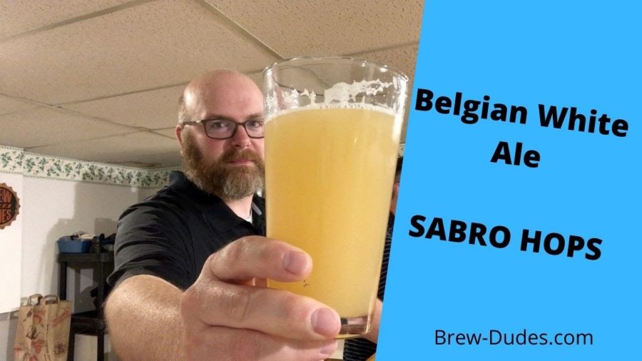 Mike holding up a glass of Sabro Hops White Ale Fermented With Hoegaarden Yeast