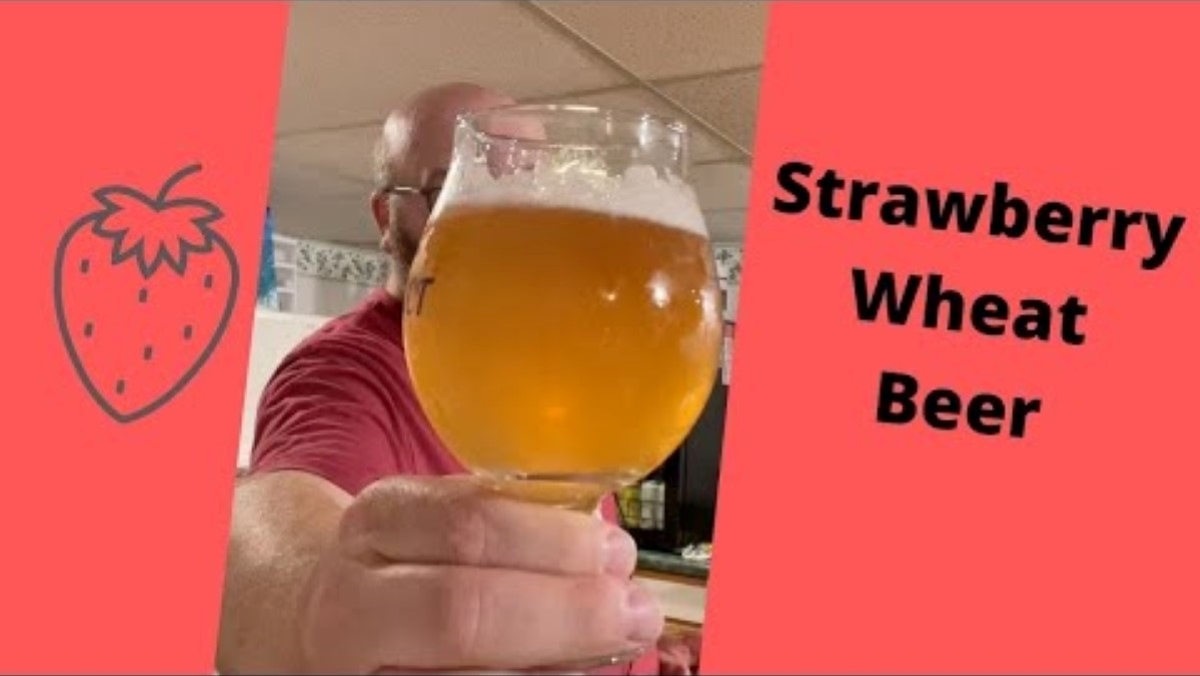 Strawberry wheat beer in a glass to show off its color